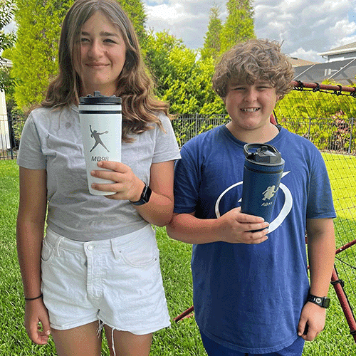 Two young athletes holding bottles with their own logos